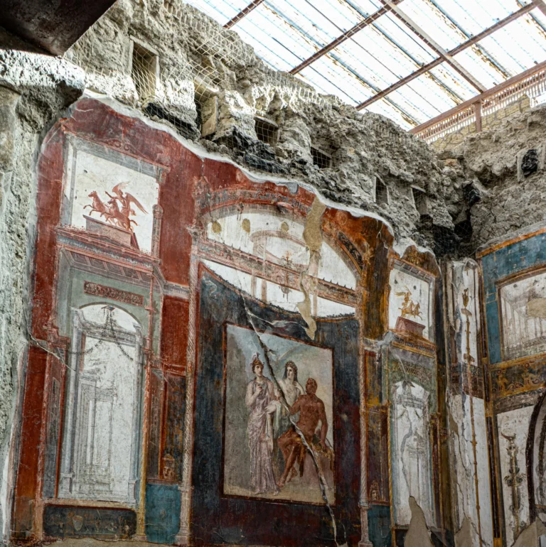 In the heart of Herculaneum, a panel within the College of the Augustali reveals the traces of ancient artistry. a subtle reminder of Roman life.