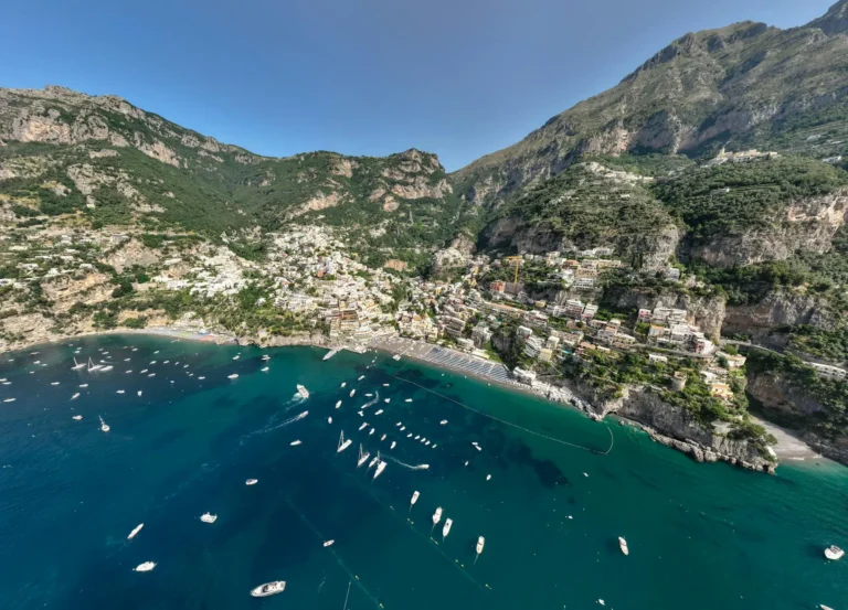 Iconic coastal scenery of Positano, Italy. Colorful houses cling to the steep cliffs descending to the Mediterranean Sea, a popular tourist destination on the Amalfi Coast known for its beauty and charm.